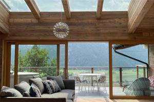 a living room with a couch and a table at Kitzbüheler Alpenpenthouse *private Sauna&Whirlpool* by STELLENBERG living in Hollersbach im Pinzgau