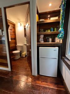a kitchen with a white refrigerator in a room at Colinda Cabanas in Caye Caulker