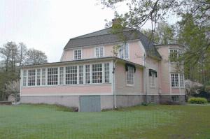 a large brick house with a large window at Solvikens Pensionat in Ingelstad