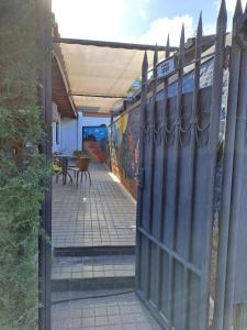 an open gate to a patio with a table at PORTAL ANDINO in Godoy Cruz