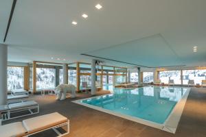 a large swimming pool with a polar bear in a room at White Angel Hotel in Breuil-Cervinia