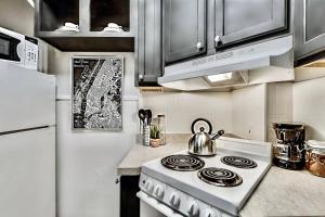 a kitchen with a stove with a tea kettle on it at Lower-Greenville Landing Close to Everything in Dallas