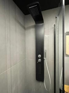 a shower with a black shower head in a bathroom at Chiatamone Luxury Home in Naples