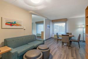 a living room with a couch and a table at Best Western PLUS Executive Hotel Richmond in Richmond