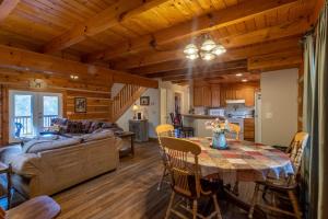 a dining room and living room with a table and a couch at River Ridge in Boone