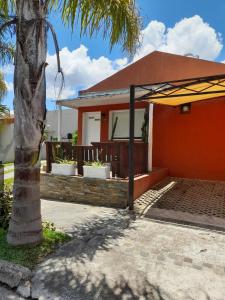 a house with a palm tree and an umbrella at El Zohar 5 pax in Federación
