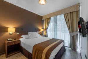 a hotel room with a bed and a window at Apart Hotel Elite Las Condes in Santiago +28 photos