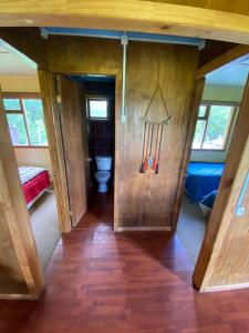 a small bathroom with a toilet in a room at Cabañas Vista al Paine in Torres del Paine