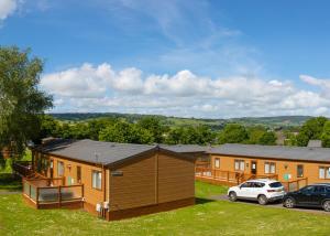 a row of houses with cars parked in a yard at Ladys Mile Holiday Park in Dawlish