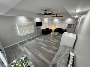 a living room with a couch and a ceiling fan at Beach Road Hale in Keaau