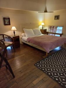 a bedroom with a bed and two chairs and a table at Colombier du château in Vitry-la-Ville