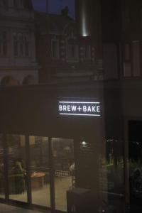 a sign that says brew t bake in a window at Amazing Luxury One Bedroom Apartment in the heart of Preston in Preston