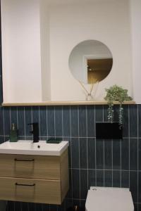 a bathroom with a sink and a toilet and a mirror at Amazing Luxury One Bedroom Apartment in the heart of Preston in Preston