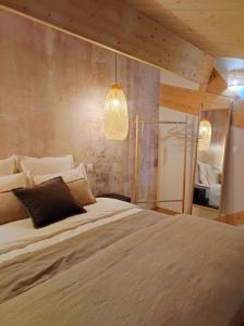 a bedroom with a large bed and two lights at La Gourgasse Vieille in Béziers