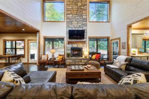 a living room with leather furniture and a fireplace at Lazy Dog in Stephens Gap