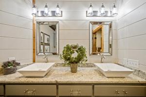 two sinks in a bathroom with two mirrors at Lazy Dog in Stephens Gap +55 photos