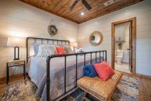 a bedroom with a bed and a chair at Lazy Dog in Stephens Gap