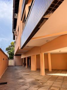 an external view of a building with a balcony at Orla Maria Apartamentos in Florianópolis
