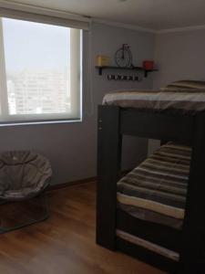 a bedroom with a bunk bed and a window at Rent apartment Viña del Mar in Viña del Mar