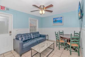 a living room with a couch and a table at 125 Atlantic Avenue Unit E - Pet Friendly! Walk To The Beach and Pier!1BR -1BA - Sleeps 2-4 guests! in Myrtle Beach