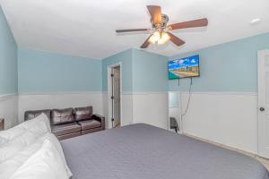 a bedroom with a bed and a ceiling fan at 125 Atlantic Avenue Unit E - Pet Friendly! Walk To The Beach and Pier!1BR -1BA - Sleeps 2-4 guests! in Myrtle Beach