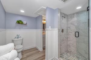 a bathroom with a shower and a toilet at 125 Atlantic Avenue Unit D - Pet Friendly! Walk To the Beach and Pier! 1BR -1BA - Sleeps 2-4 guests! in Myrtle Beach