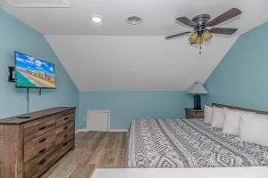 a bedroom with a bed and a ceiling fan at 125 Atlantic Avenue Unit H - Pet Friendly! Walk To The Beach and Pier!1BR -1BA - Sleeps 4 guests! in Myrtle Beach