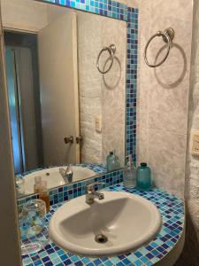 a bathroom with a sink and a mirror at Esquina Verde in Bella Vista +14 photos