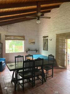 a dining room with a table and four chairs at Esquina Verde in Bella Vista