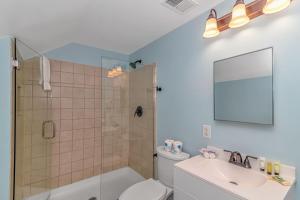 a bathroom with a shower and a toilet and a sink at 125 Atlantic Avenue Unit G2 -Pet Friendly! Loft Apartment -Sleeps 2-4 guests! in Myrtle Beach +31 photos
