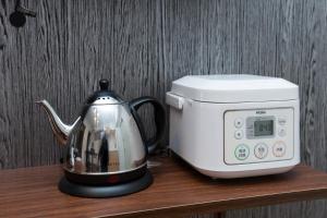 a tea kettle next to a toaster on a shelf at Amber Iidabashi - Vacation STAY 87112v in Tokyo