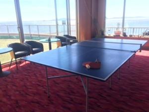 a ping pong table in a room with chairs at Hotel Mikawa Kaiyoukaku - Vacation STAY 90625v in Gamagori