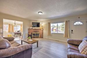 a living room with two couches and a fireplace at Hike, Bike and Fish Gem with Hot Tub in Woodland Park in Woodland Park