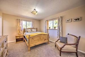 a bedroom with a bed and a chair at Hike, Bike and Fish Gem with Hot Tub in Woodland Park in Woodland Park
