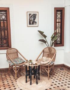 two chairs and a table in a room at Riad Dar Beldia and Spa in Marrakesh