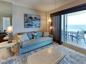 a living room with a couch and a view of the ocean at Regency Isle #609 in Orange Beach