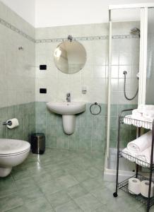 a bathroom with a sink and a toilet and a shower at AL BORGO ANTICO residenza in Pinzolo
