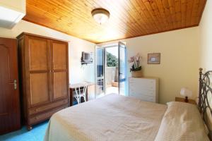a bedroom with a bed with a wooden ceiling at Hotel La Certosa in Massa Lubrense