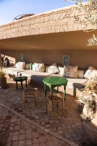 a patio with a couch and a table and chairs at Riad Dar Beldia and Spa in Marrakesh