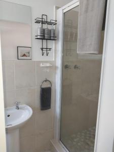a bathroom with a shower and a sink at Beachfront apartment in a secure complex in Port Alfred