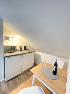 a kitchen with a table with wine glasses on it at Westendperle am Olympiastadion in Berlin