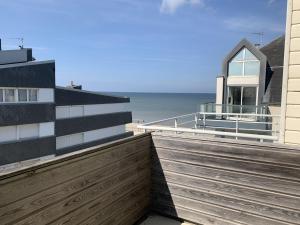 a building on the beach with the ocean in the background at Appartement proche plage avec parking et balcon - FR-1-482-102 in Fort-Mahon-Plage