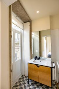 a bathroom with a sink and a mirror at Bright studio with terrace in Porto