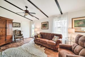 a living room with a couch and a ceiling fan at Carmine Cottage with Porch on Beautiful 60-Acre Farm in Carmine