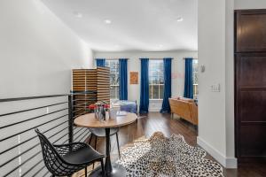 a balcony with a table and chairs and a living room at The Murray in Bentonville