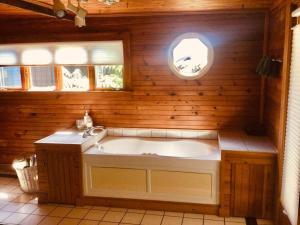 a bathroom with a large tub and a sink at Wonderful Farm Escape With Swim Creek & Hiking Trails in Saugerties