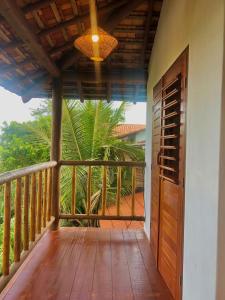 a porch of a house with a wooden door at Mirante Caraiva in Caraíva