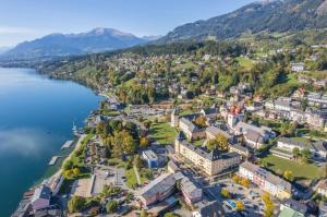 an aerial view of a town on the shore of a lake at Seeblick Millstatt in Millstatt