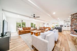 a living room with white furniture and a fireplace at The Beehive in Lake Hamilton