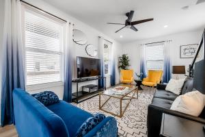 a living room with a blue couch and chairs at The Hub in Fayetteville